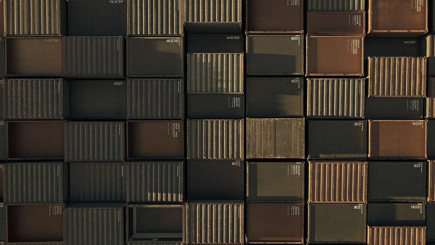 Shipping containers stacked in a grid, seen from above